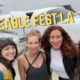 Four happy lady friends prepare to take off, smiling in front of a small jet plane.